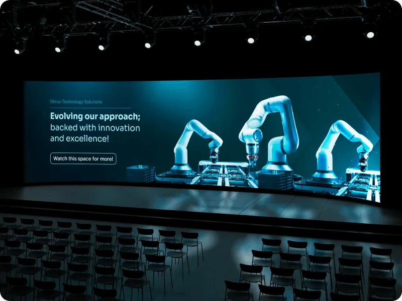Dhruv Technology Solutions event stage design featuring robotic arms and innovation messaging