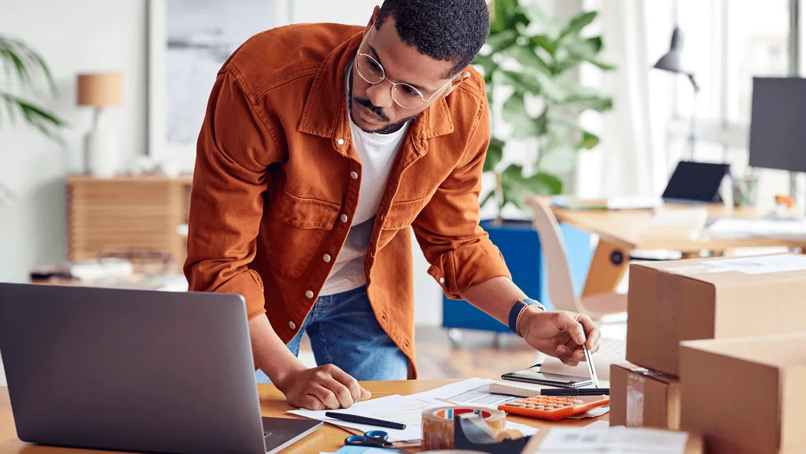 E-commerce business owner managing online orders and inventory from a laptop