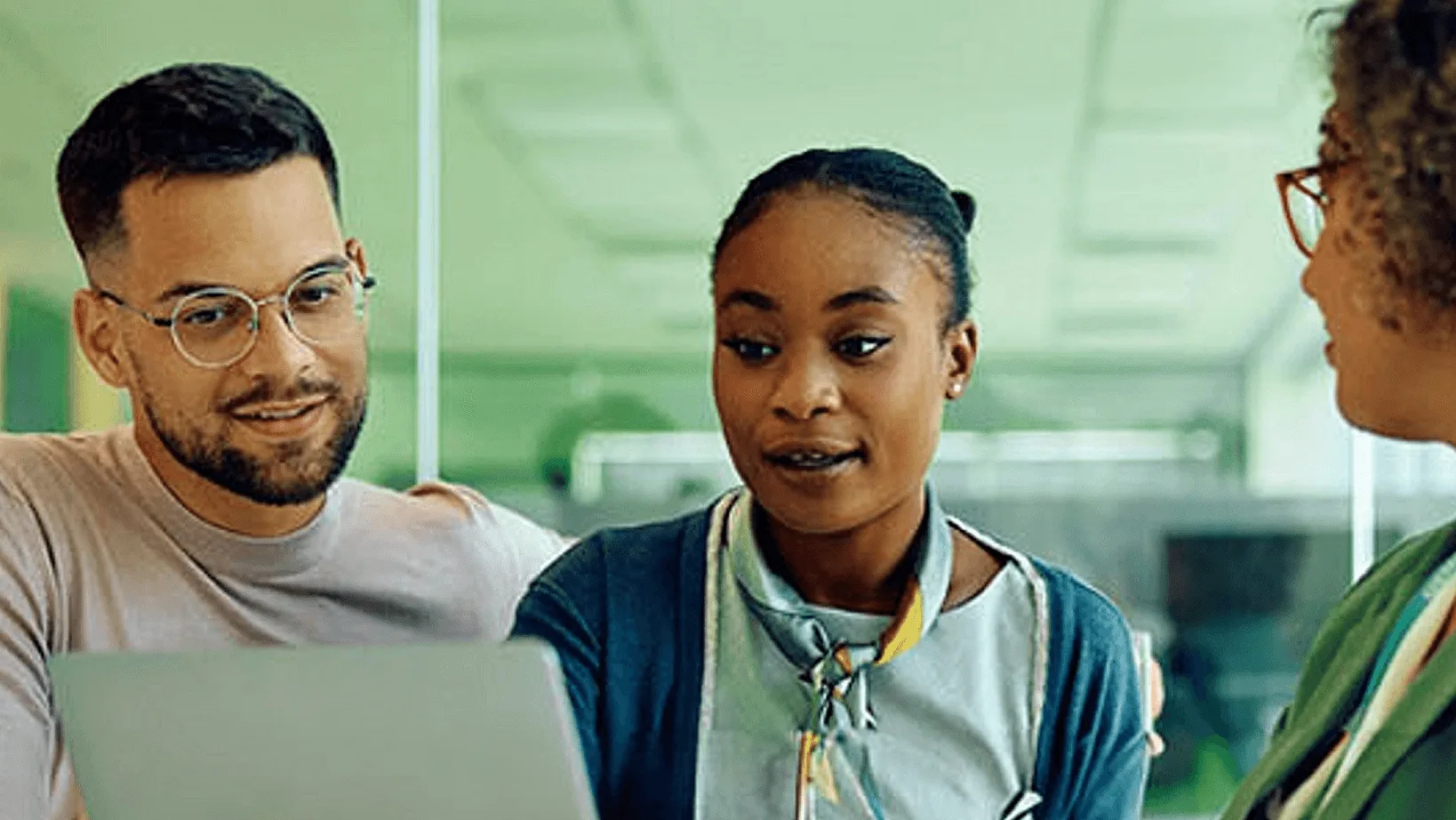 HR team reviewing employee information together on a laptop