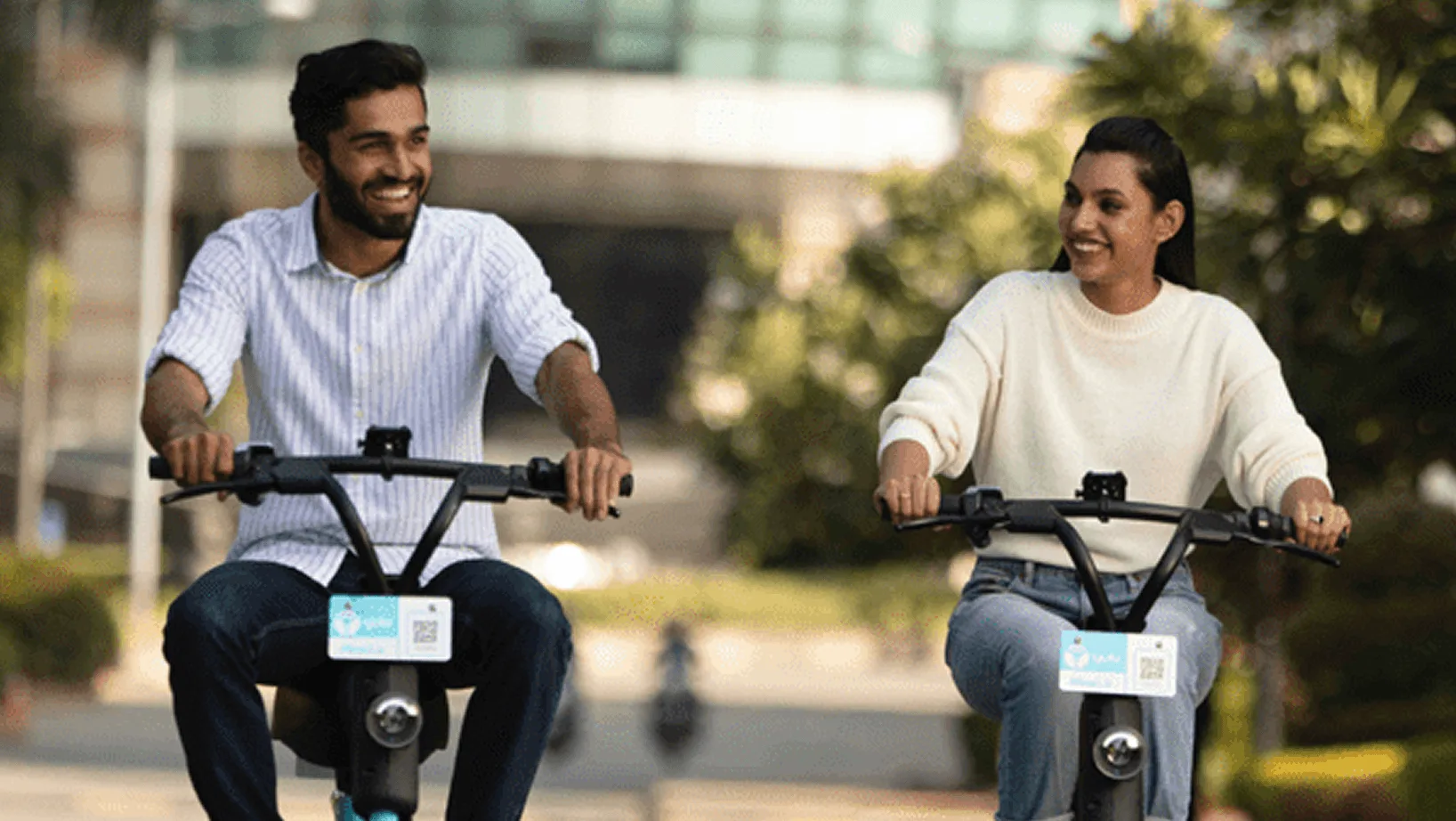 Two riders using electric mobility vehicles in an urban setting