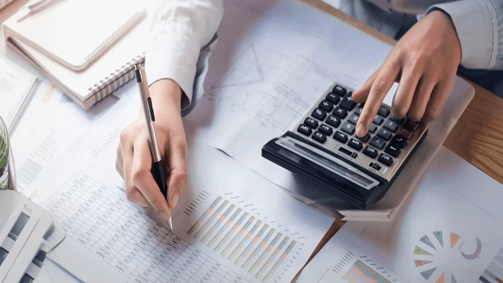 Financial professional analysing reports and calculations for fintech decision-making
