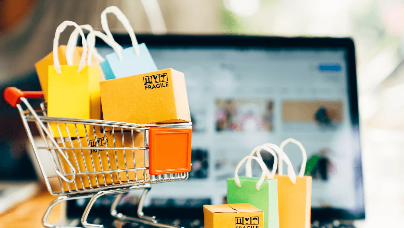 Online retail concept with shopping bags parcels and a digital storefront on a laptop
